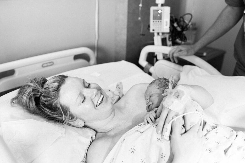 happy mom holding baby right after birth