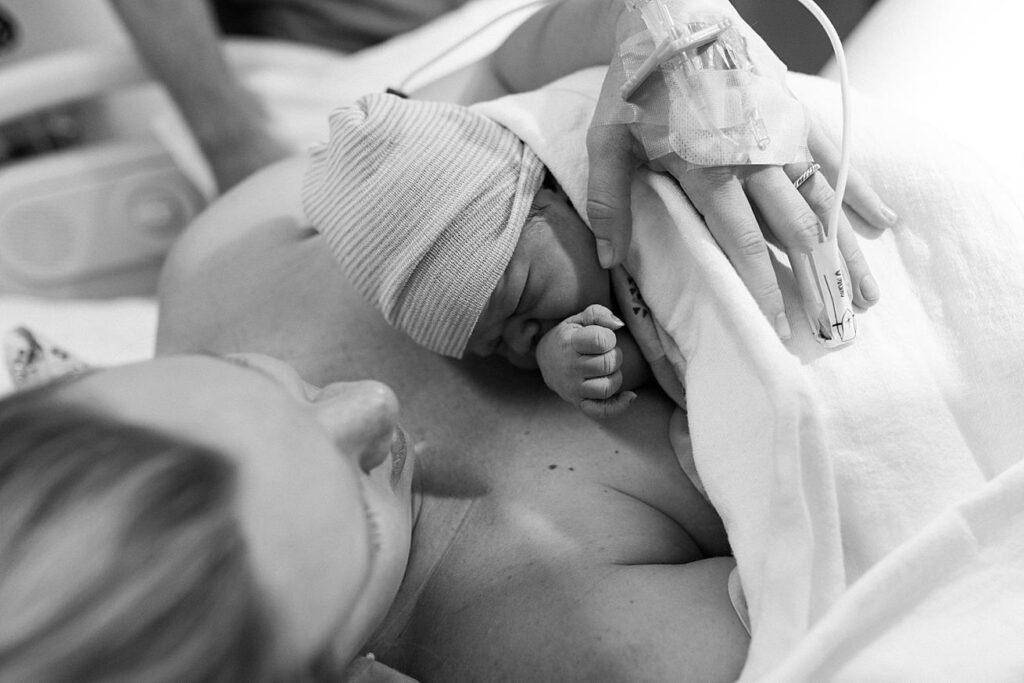 mom looking at newborn baby boy in hospital