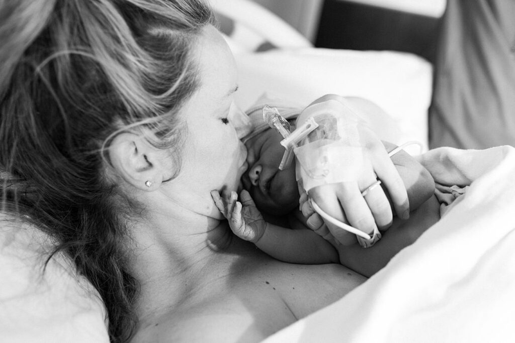 mom kissing baby boy at raleigh hospital