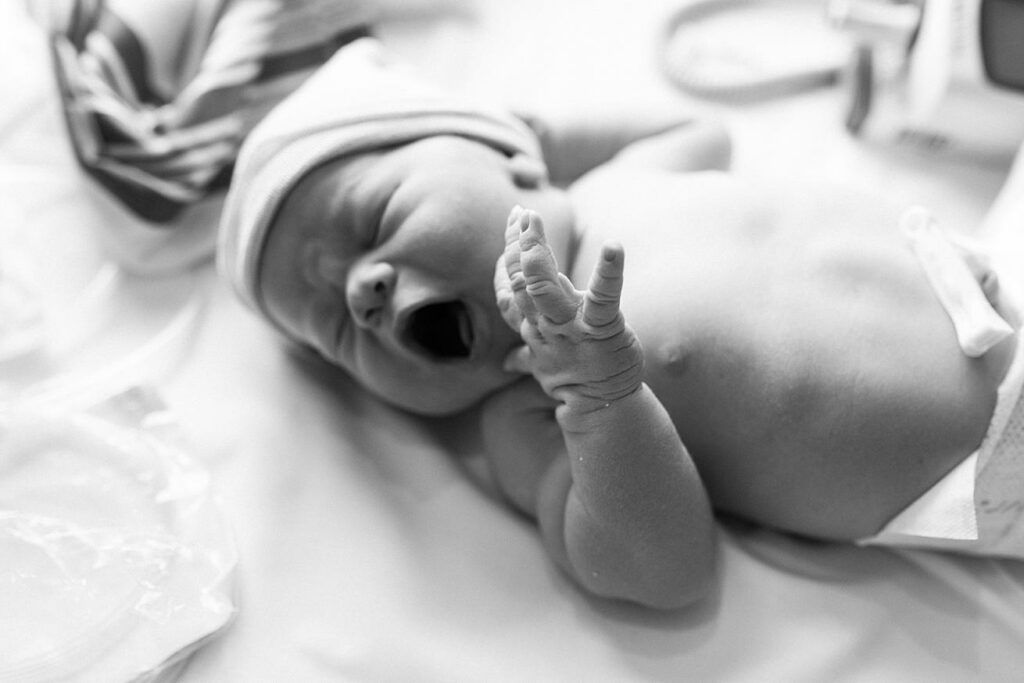 yawning baby boy in hospital warmer