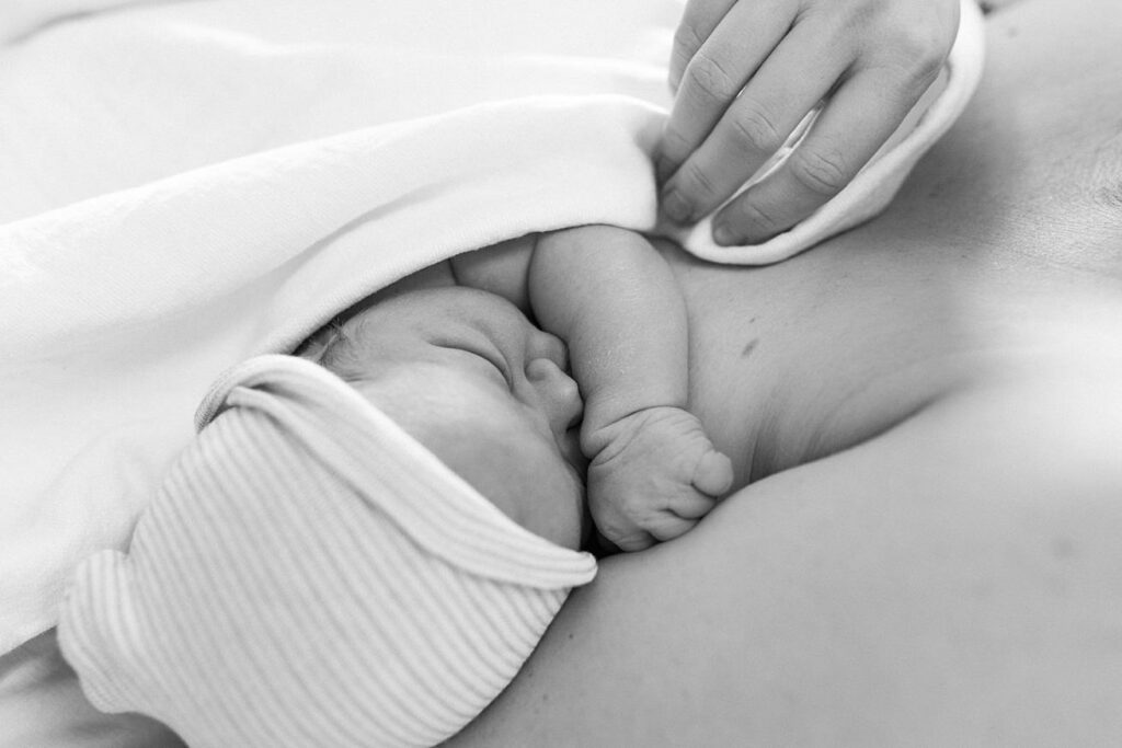 baby boy snuggling mom in hospital