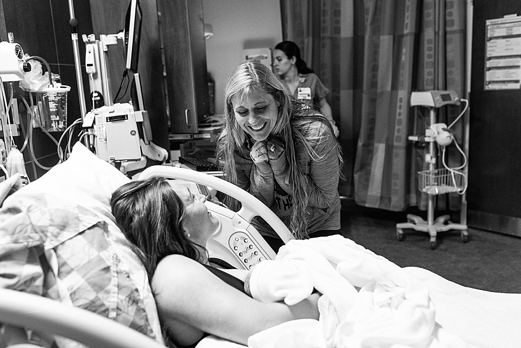 smiling grandma meeting baby in hospital