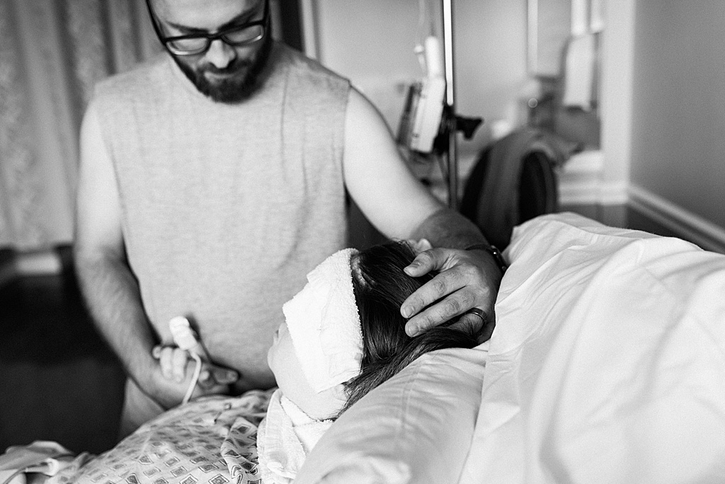 dad rubbing mom's head, hospital birth
