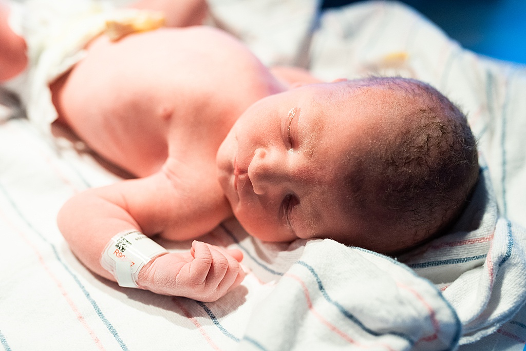 newborn baby boy on hospital warmer
