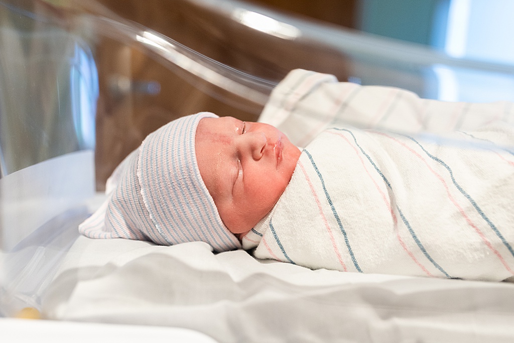 newborn baby boy in hospital bassinet