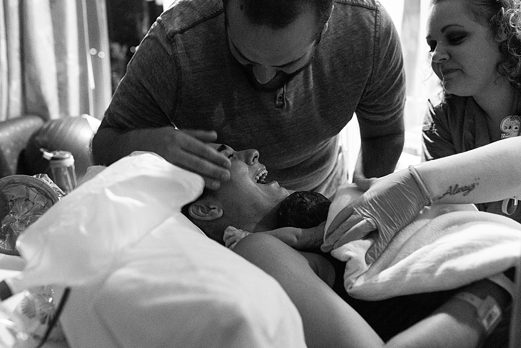 mom and dad smiling, newborn baby, hospital birth