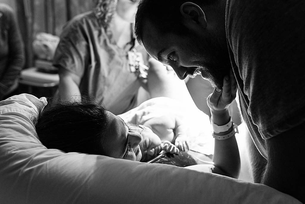 mom holding dad's face, baby born in hospital