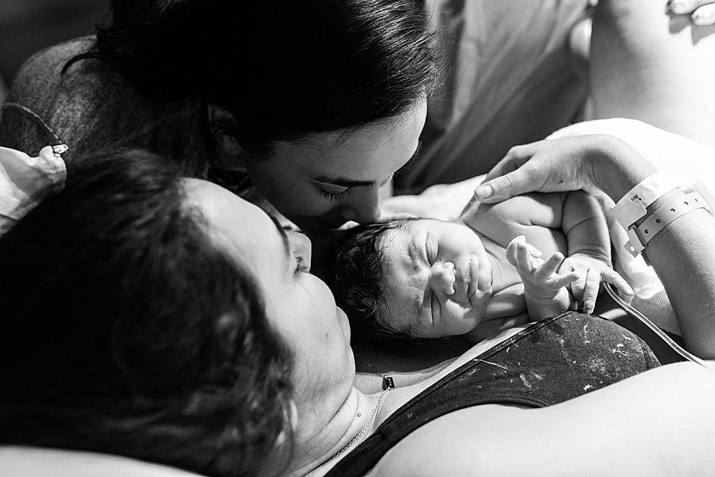 sister kissing baby girl, hospital birth